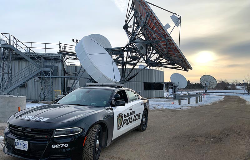 Halton police cruiser in foreground of satellite ground station