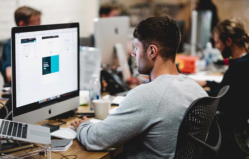 Office workstations with people sitting in front of their computers