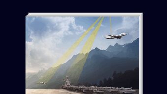 COVER IMAGE: A daytime view of a shoreline with a mountain and lush forest landscape, showing a Global Hawk UAV (Unmanned Air Vehicle) drone following the USS Gerald R Ford (CVN-78) Supercarrier, as a E-4B airplane flies above on the top-right.