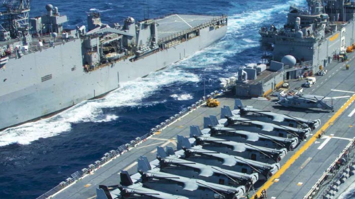 U. S. military ships on ocean carrying fighter jets
