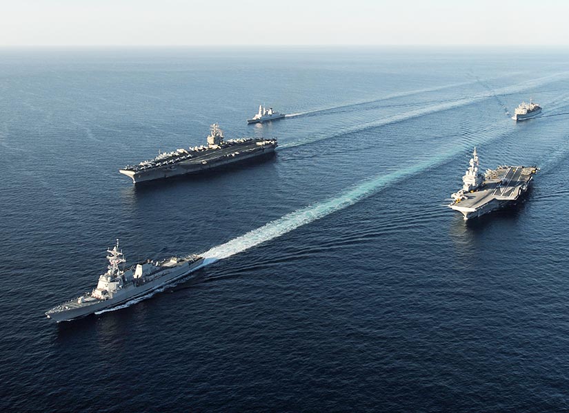 Five U.S. military ships travelling across ocean