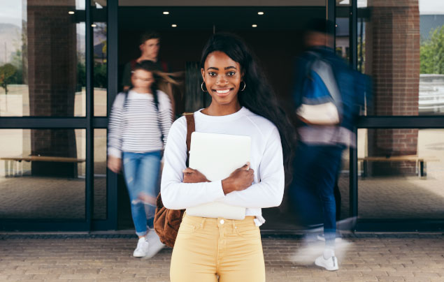 Young girl in front of school