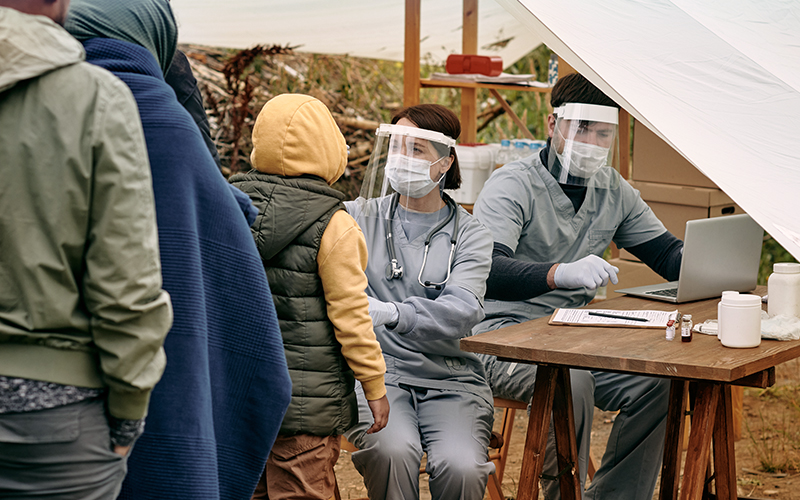 Humanitarian workers administering health checks with residents