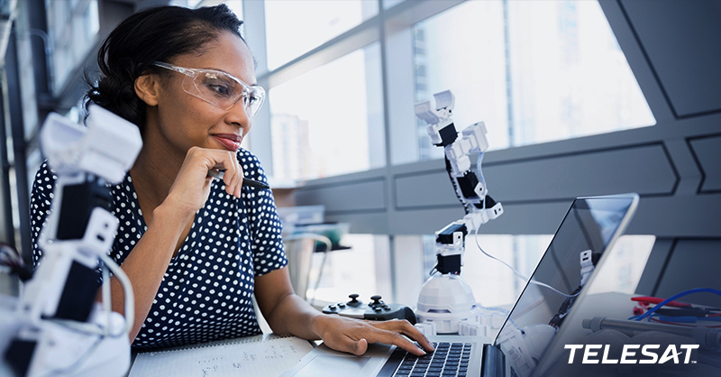 Female student in lab looking at laptop.