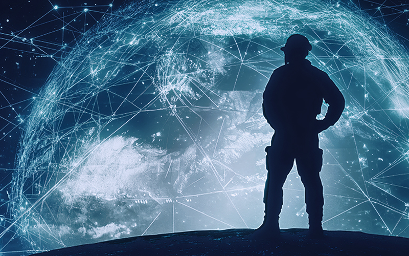 Silhouette of a soldier standing in front of a cosmic backdrop featuring Earth overlaid with glowing constellations, stars, and orbiting satellites, symbolizing global connectivity and defence.