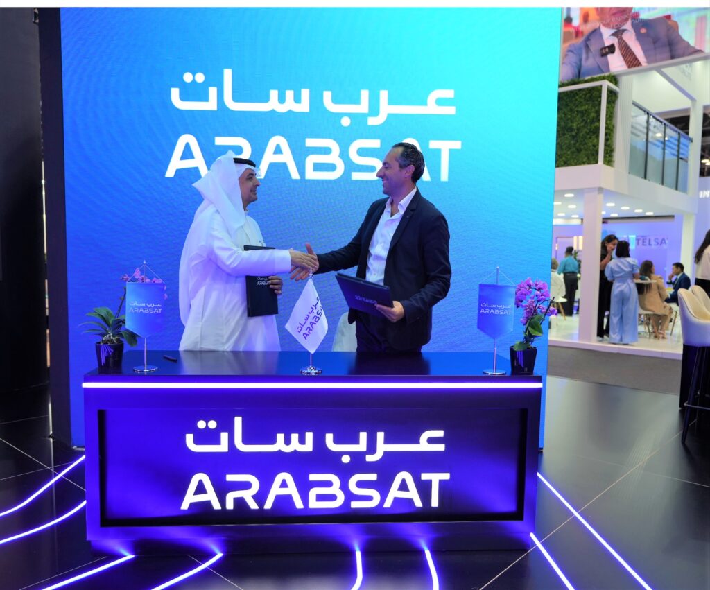 Arabsat CEO Alhamedi Alanezi and Telesat's Yanniv Betito shake hands during a signing ceremony