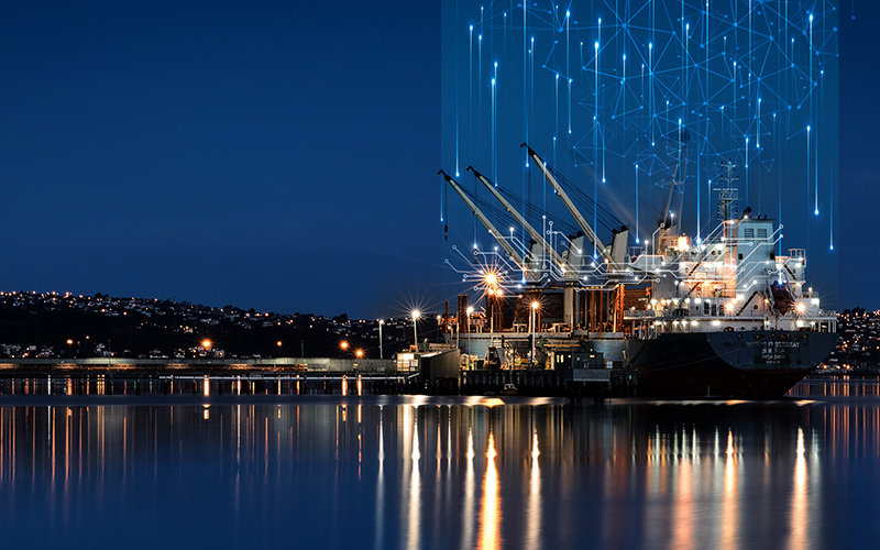 "Large illuminated ship docked at night, with glowing light trails rising into the dark sky, representing satellite links and global maritime connectivity.