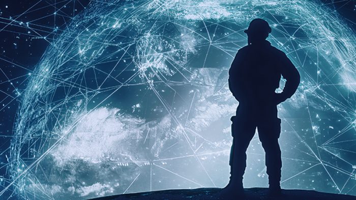 Silhouette of a soldier standing in front of a cosmic backdrop featuring Earth overlaid with glowing constellations, stars, and orbiting satellites, symbolizing global connectivity and defence.