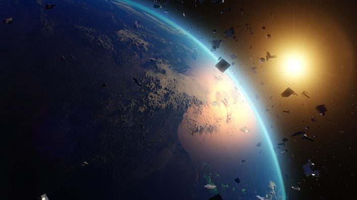 Low Earth orbit satellites in space above the Earth with Sun in the horizon